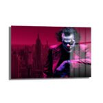 Joker'in Şehirdeki İzi: Kırmızı Gotham Temalı Temperli Cam Tablo, Joker'in kırmızı ve mor tonlarında Gotham silüeti önünde gizemli duruşunu gösteren, modern ve dayanıklı bir duvar dekorasyonu.