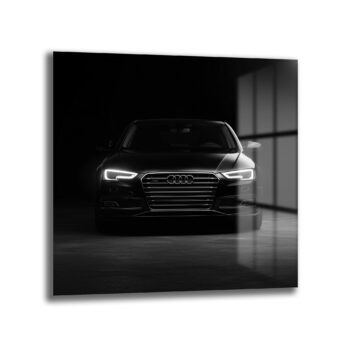 Anasayfa Duvar Dekoru Karanlık bir ortamda, parlak farları açık, önden çekilmiş siyah renkli modern Audi otomobilin cam tablo görünümü.
